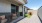 a backyard with a dog house and patio furniture