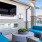 an outdoor patio lounge with a tv